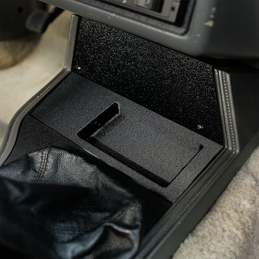 Car console with a black compartment and leather jacket inside