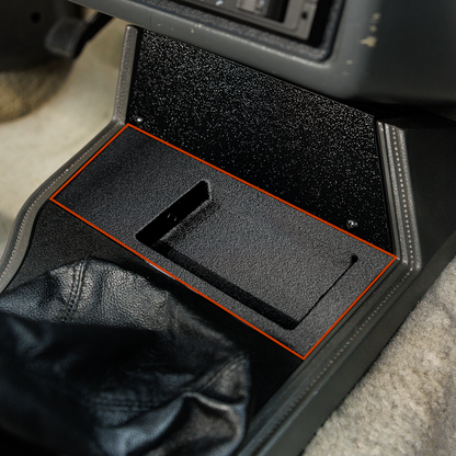 Car console with a tray and a folded jacket inside
