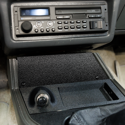 Car stereo system with a CD player and radio in a vehicle interior.