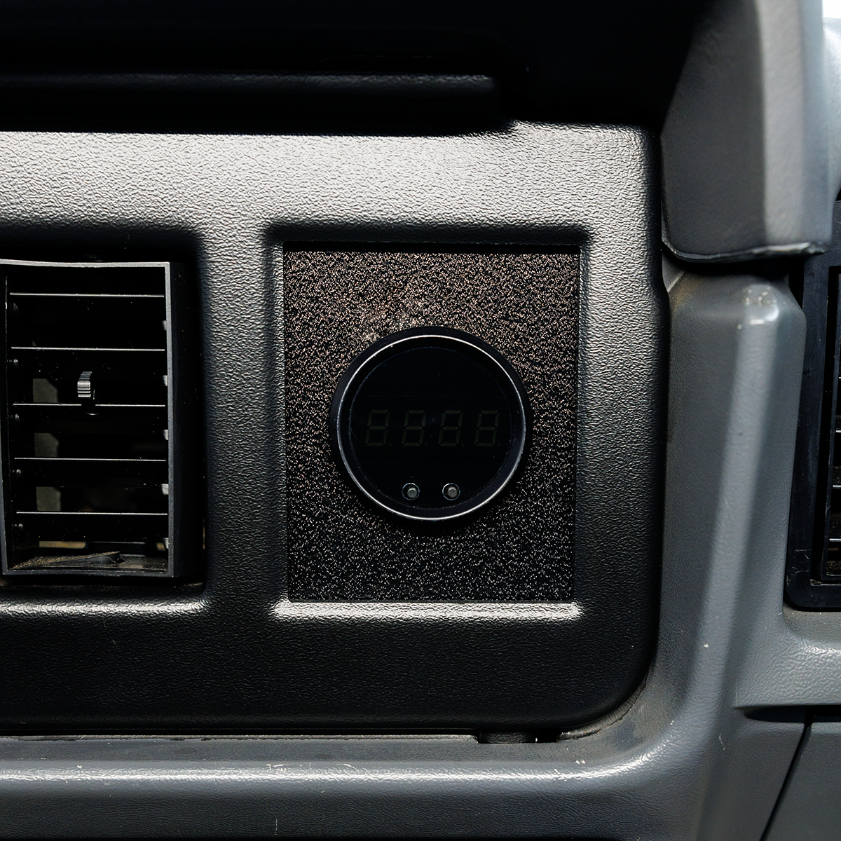 Car interior with air vent and digital display