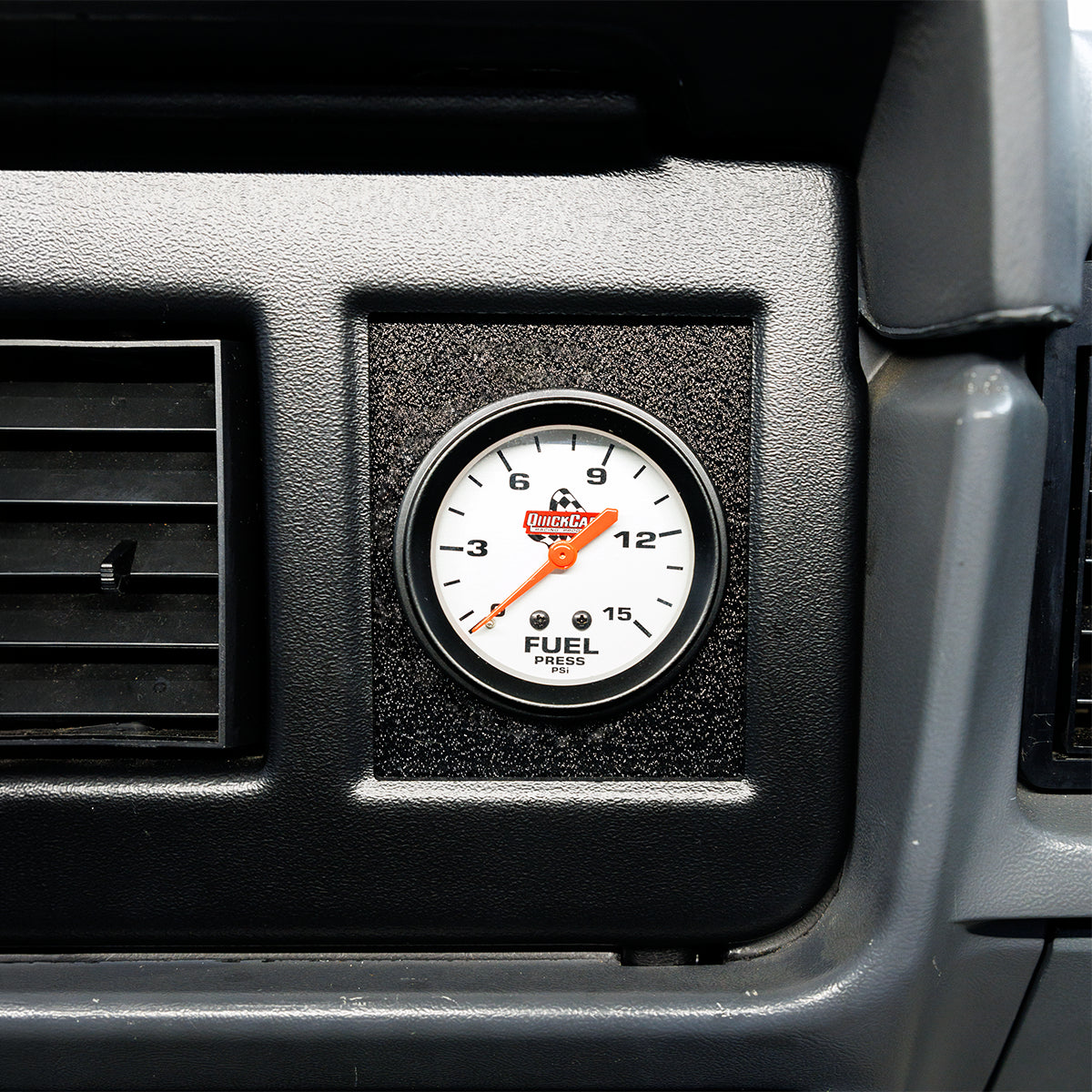 Fuel gauge in a vehicle's dashboard with a visible brand logo.