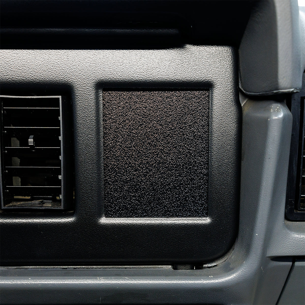 Car interior air vent with black grille